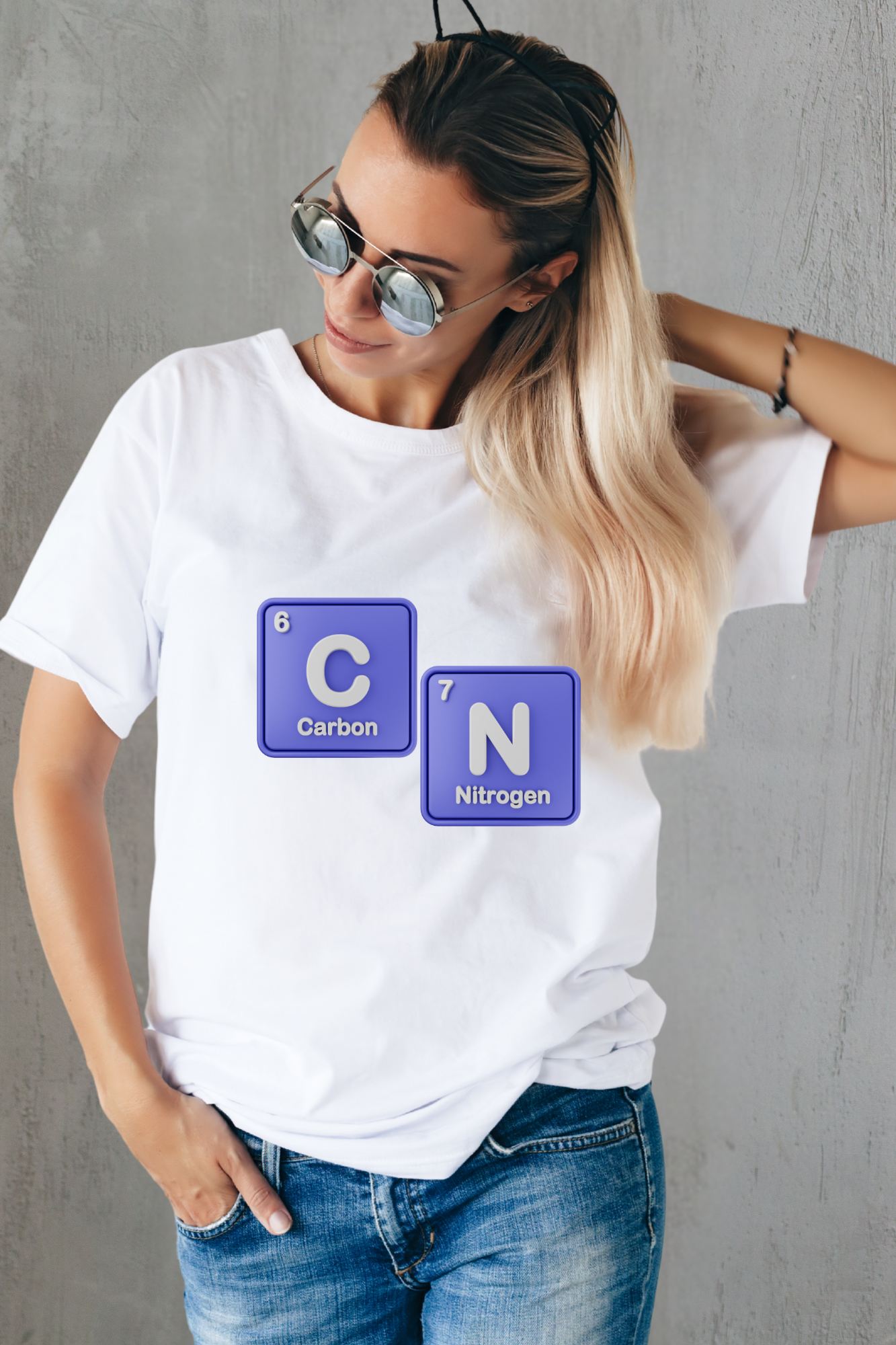 Person wearing a white t-shirt with 67 chemical element symbols on a gray background