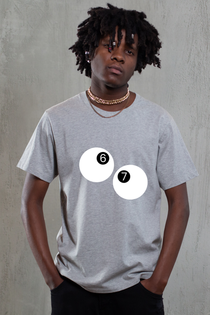 Person wearing a gray t-shirt with two white circles and numbers on a plain background