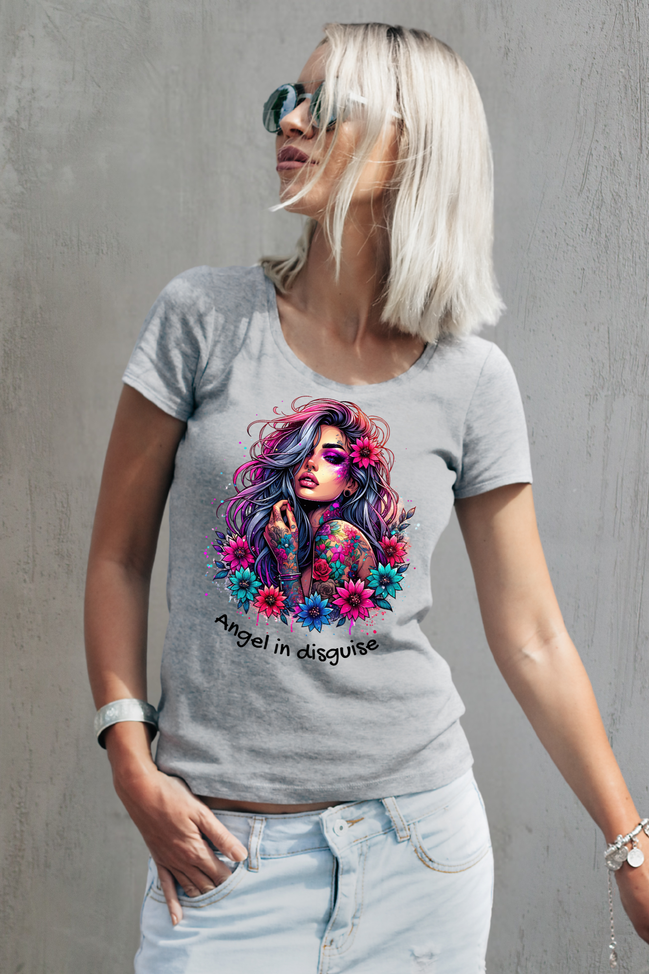 Woman wearing a gray t-shirt with a colorful graphic design and text.