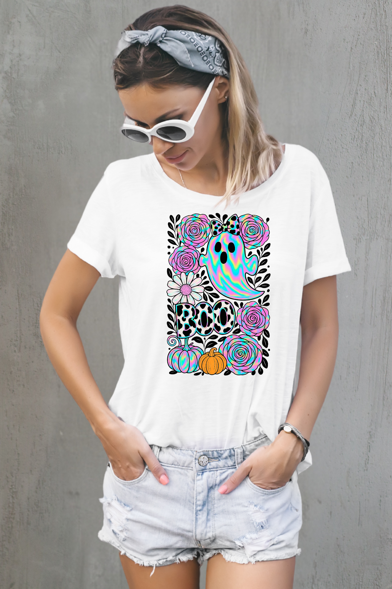 Woman wearing a white t-shirt with a colorful graphic design against a white background