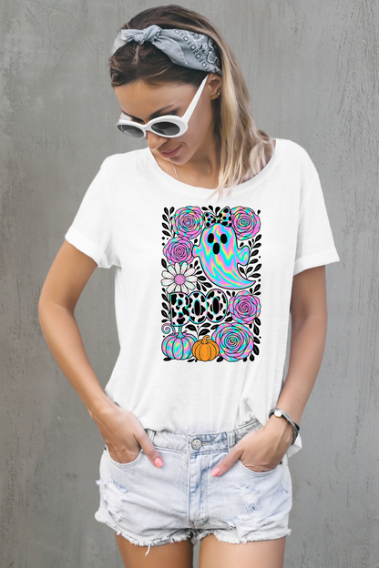 Woman wearing a white t-shirt with a colorful graphic design against a white background