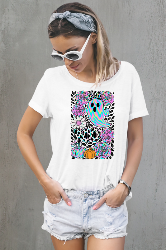 Woman wearing a white t-shirt with a colorful graphic design against a white background