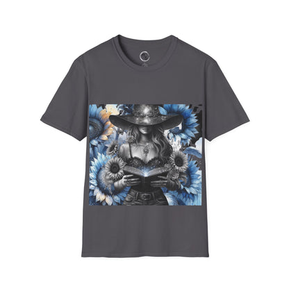 Gray t-shirt with a graphic design of a witch holding a book surrounded by flowers on a white background