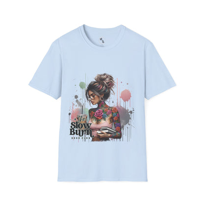 Light blue t-shirt with a graphic design of a woman with tattoos and text on a white background