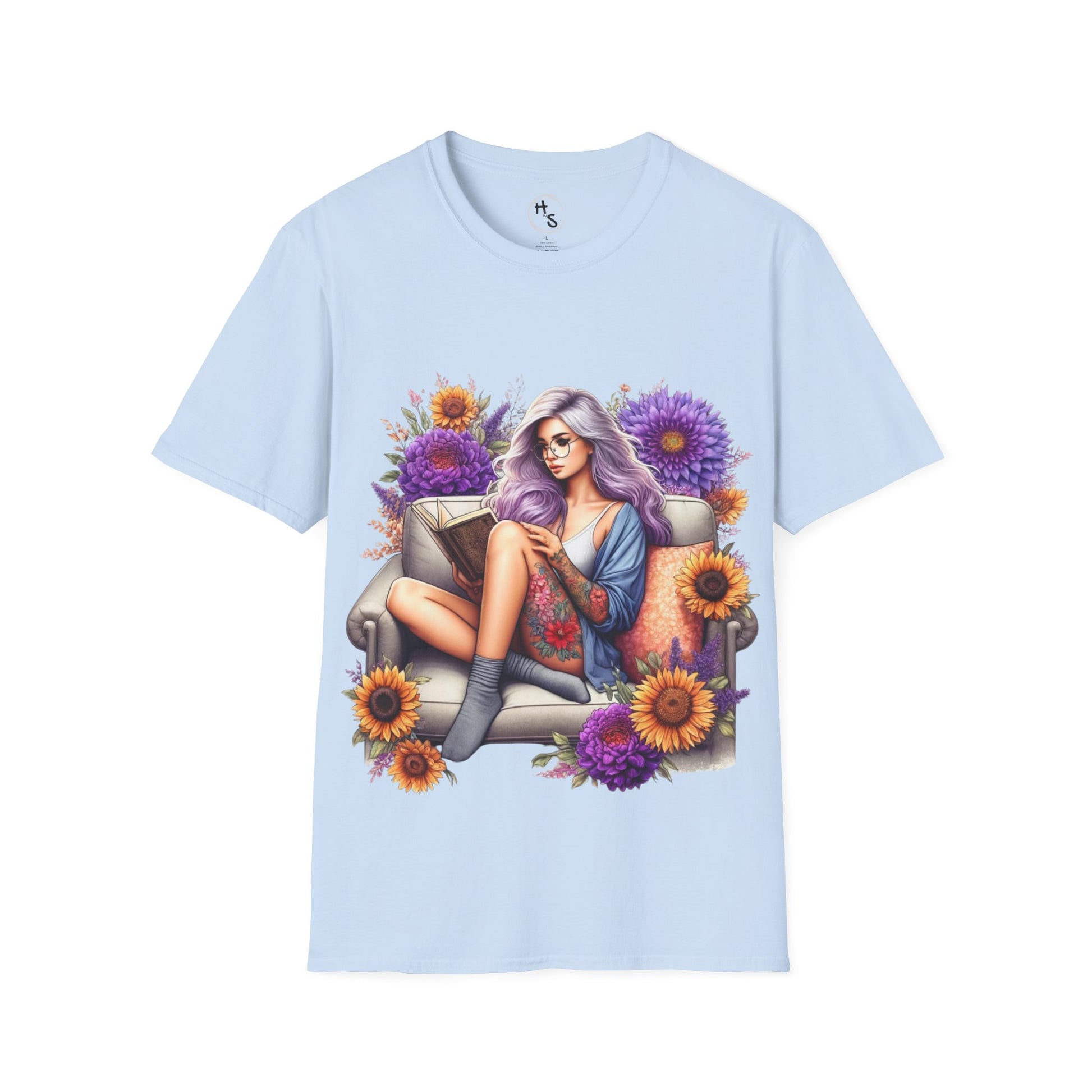 Light blue t-shirt with a colorful graphic of a woman sitting on a couch surrounded by flowers.