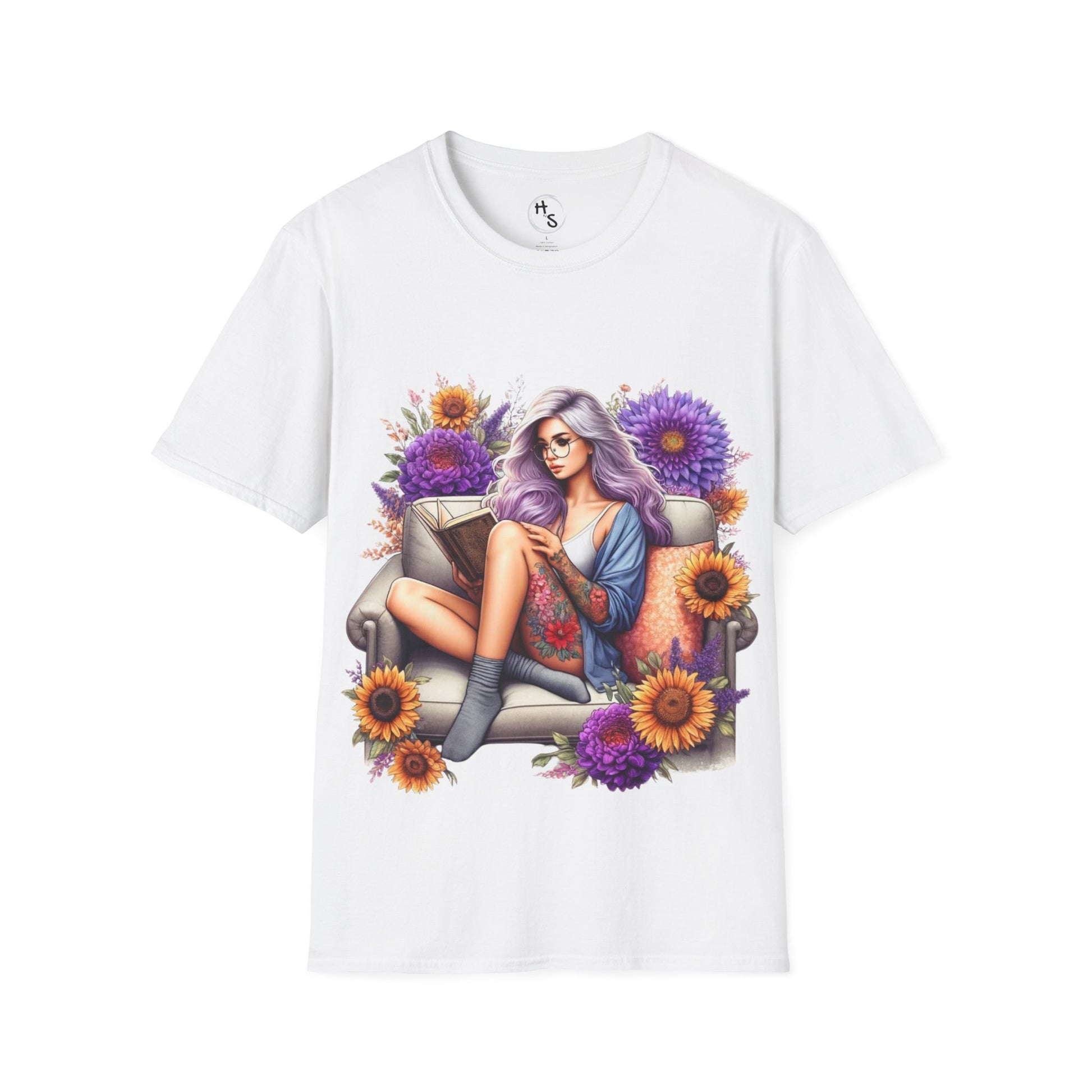 White t-shirt with a colorful graphic of a woman sitting on a couch surrounded by flowers on a white background.