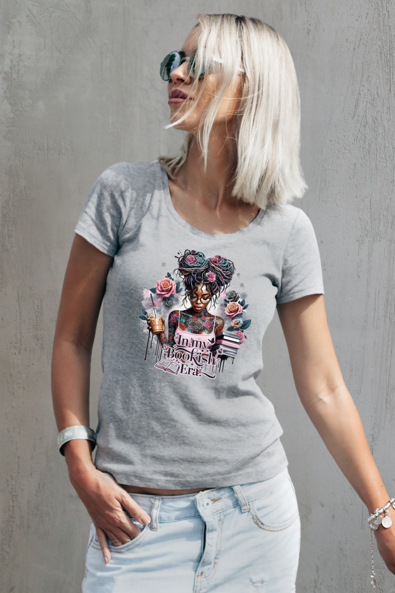 Woman wearing a gray t-shirt with a colorful graphic design against a gray background