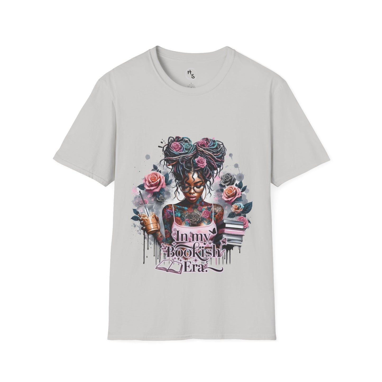 Gray t-shirt with a graphic design of a woman with tattoos and flowers, holding books and a coffee, on a white background.