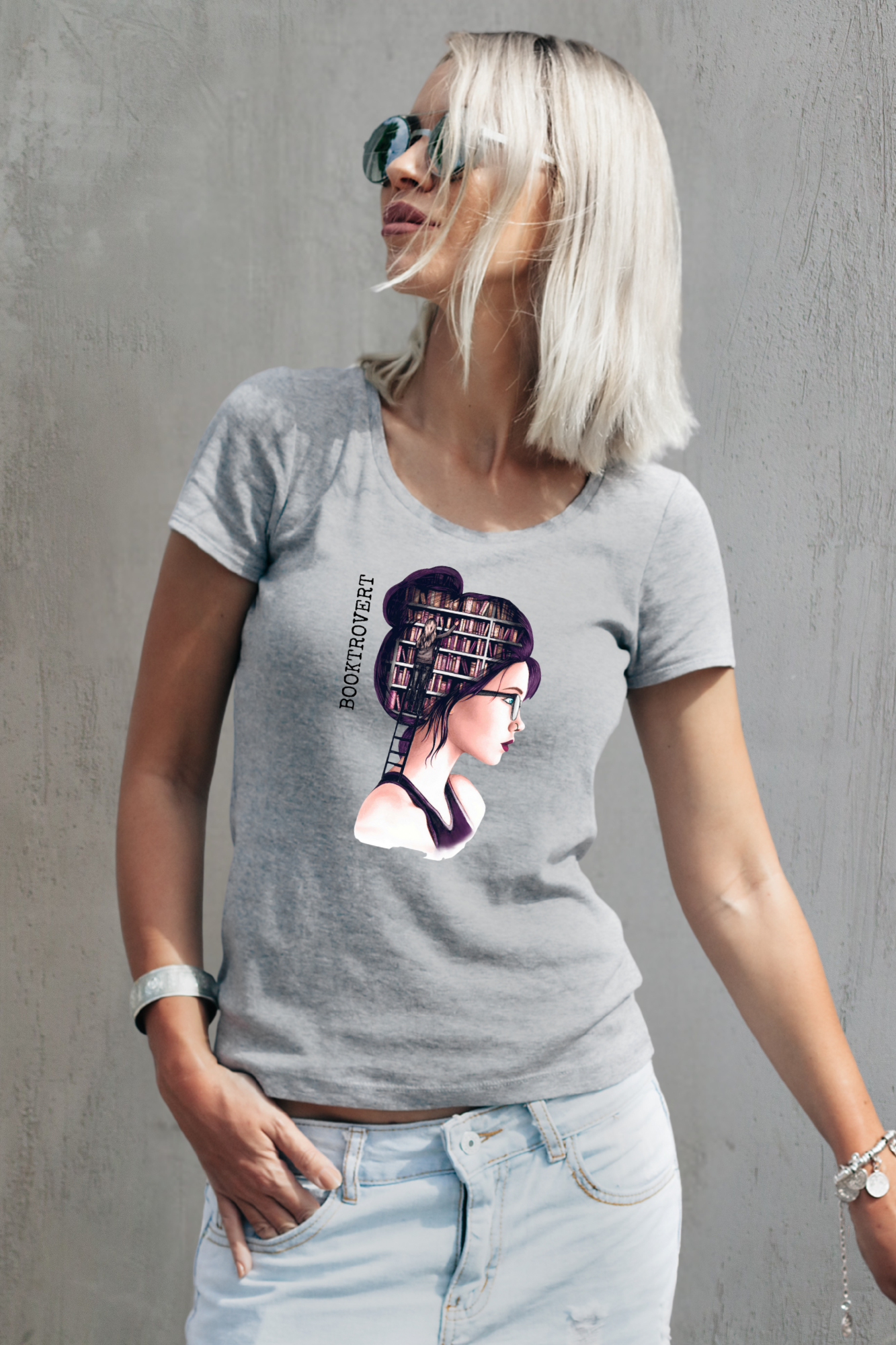 Woman wearing a gray t-shirt with a graphic design against a gray background