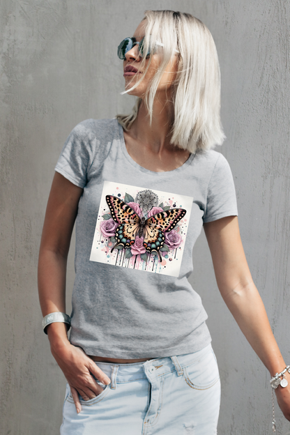 Woman wearing a gray t-shirt with a butterfly and flower design against a gray background