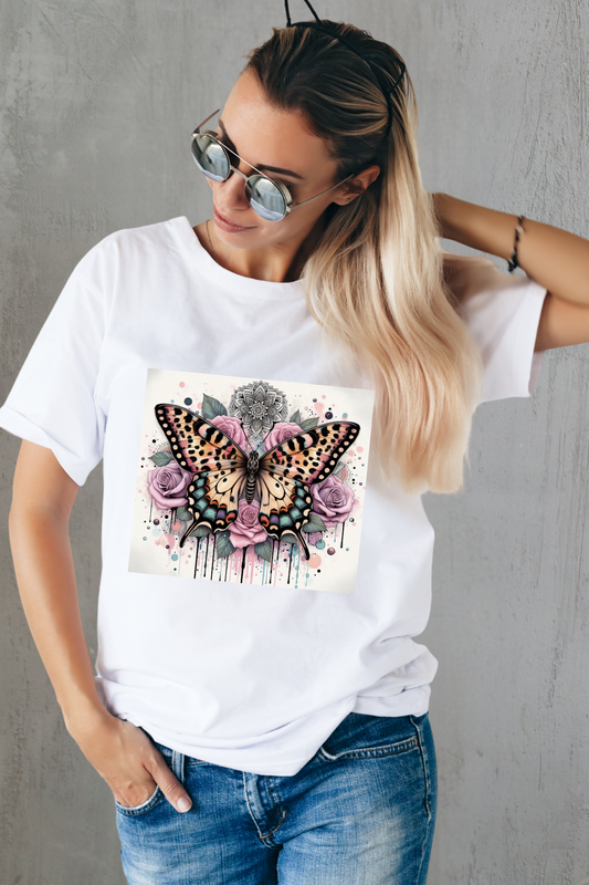 Woman wearing a white t-shirt with a butterfly and floral design against a gray background