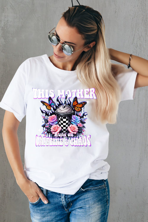 Woman wearing a white t-shirt with colorful graphic design and text.