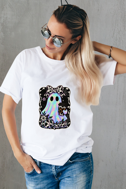 Person wearing a white t-shirt with a colorful ghost graphic design.