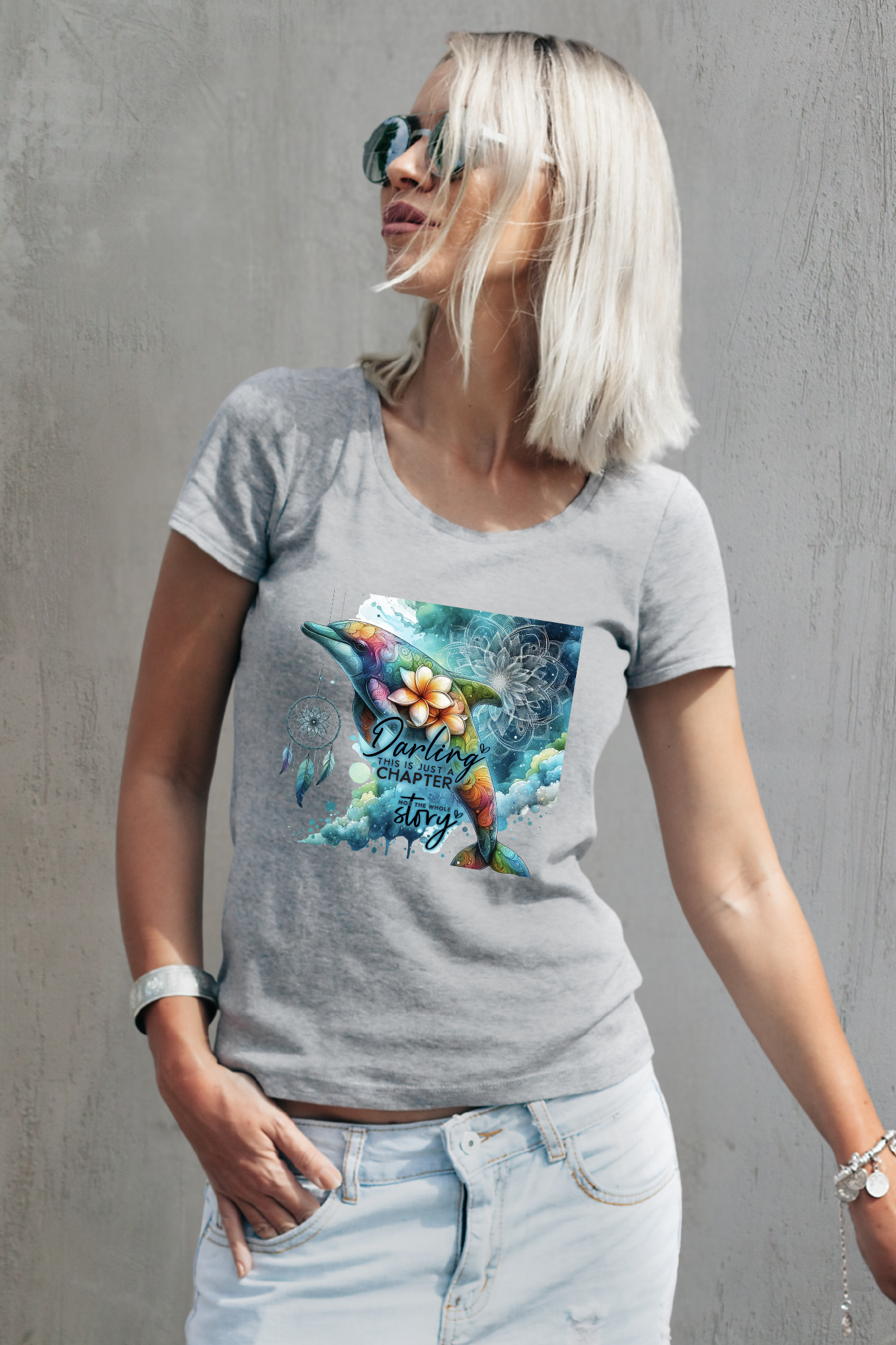 Grey shirt featuring a colorful bohemian dolphin with floral accents and dreamcatcher detail.