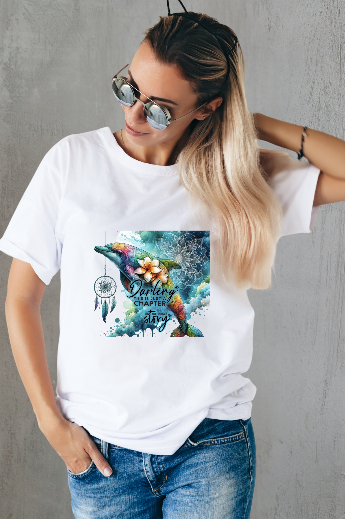 White shirt featuring a colorful bohemian dolphin with floral accents and dreamcatcher detail.