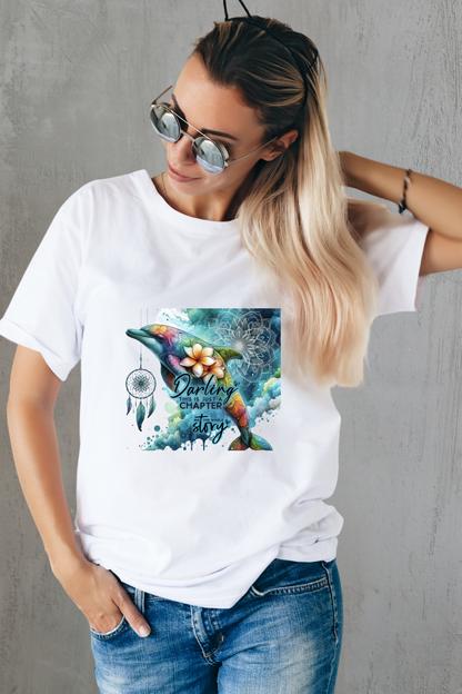 White shirt featuring a colorful bohemian dolphin with floral accents and dreamcatcher detail.