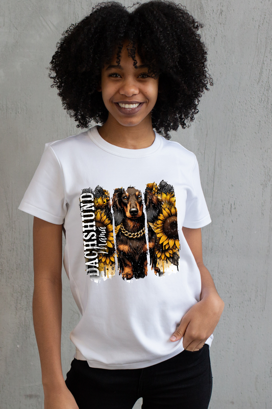 Person wearing a white t-shirt with a graphic design of a dachshund and sunflowers on a gray background
