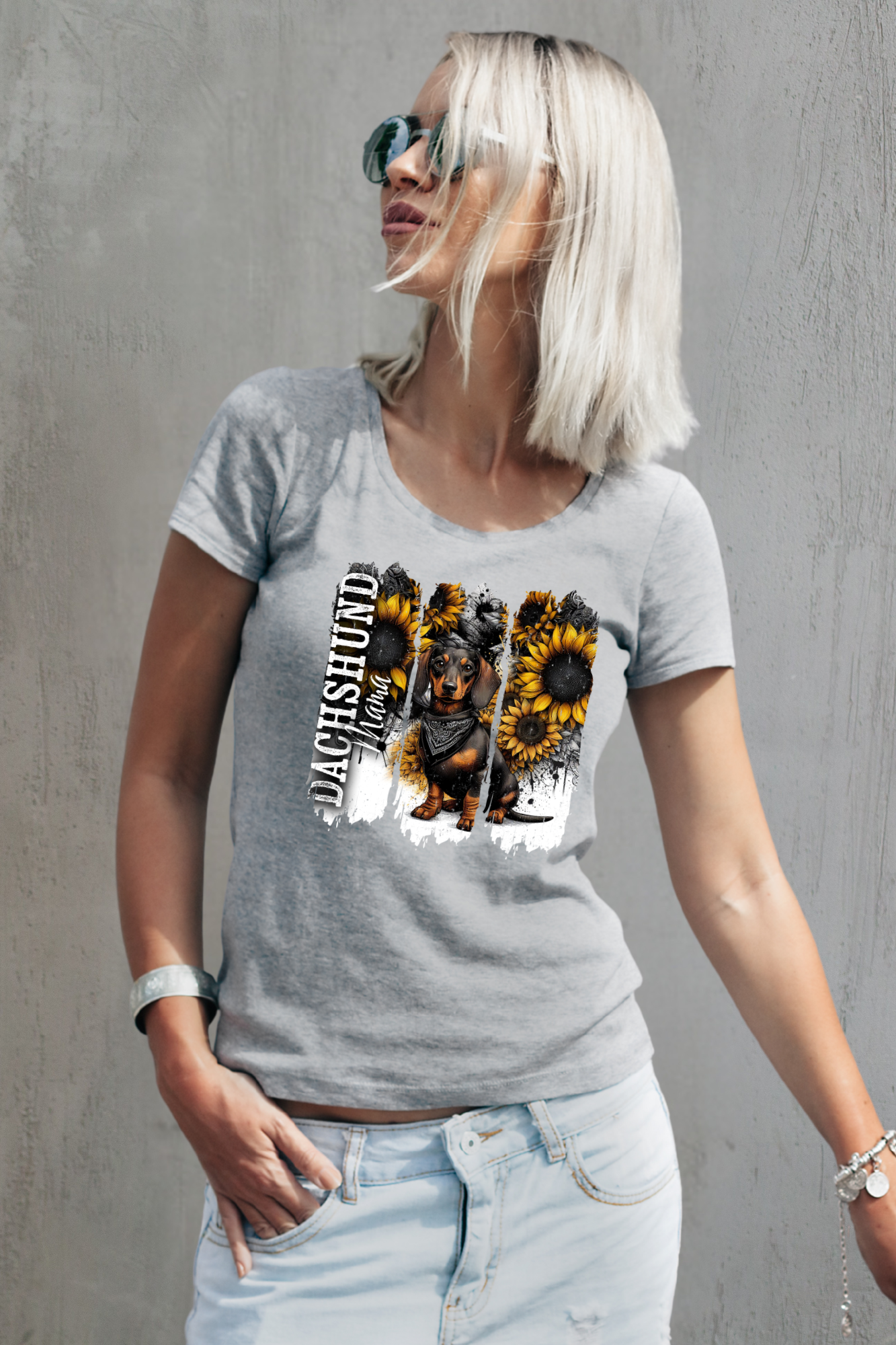 Woman wearing a gray t-shirt with a dachshund and sunflower design against a gray background