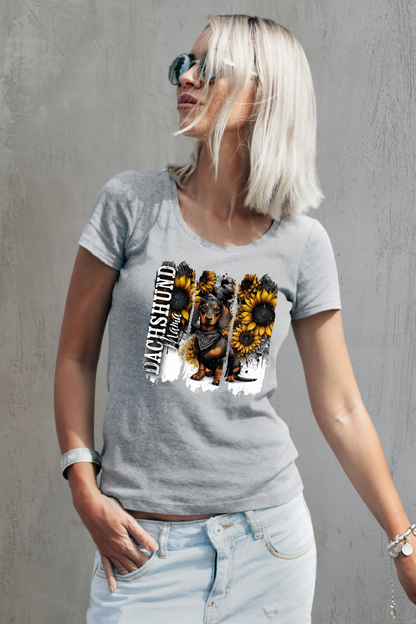 Woman wearing a gray t-shirt with a dachshund and sunflower design against a gray background