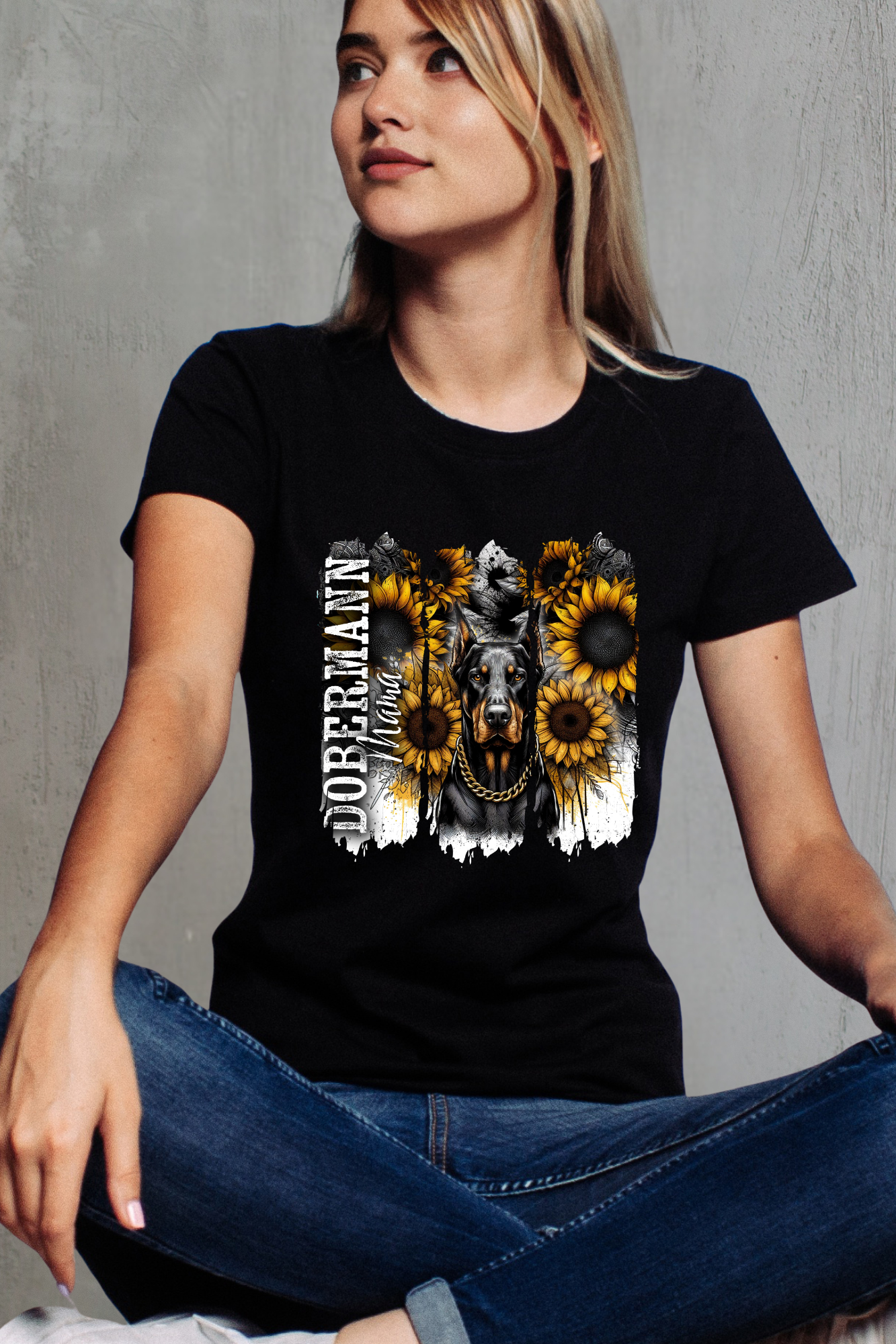 Person wearing a black t-shirt with a graphic design of a dog and sunflowers on a gray background