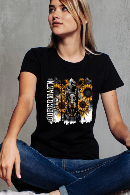 Person wearing a black t-shirt with a graphic design of a dog and sunflowers on a gray background