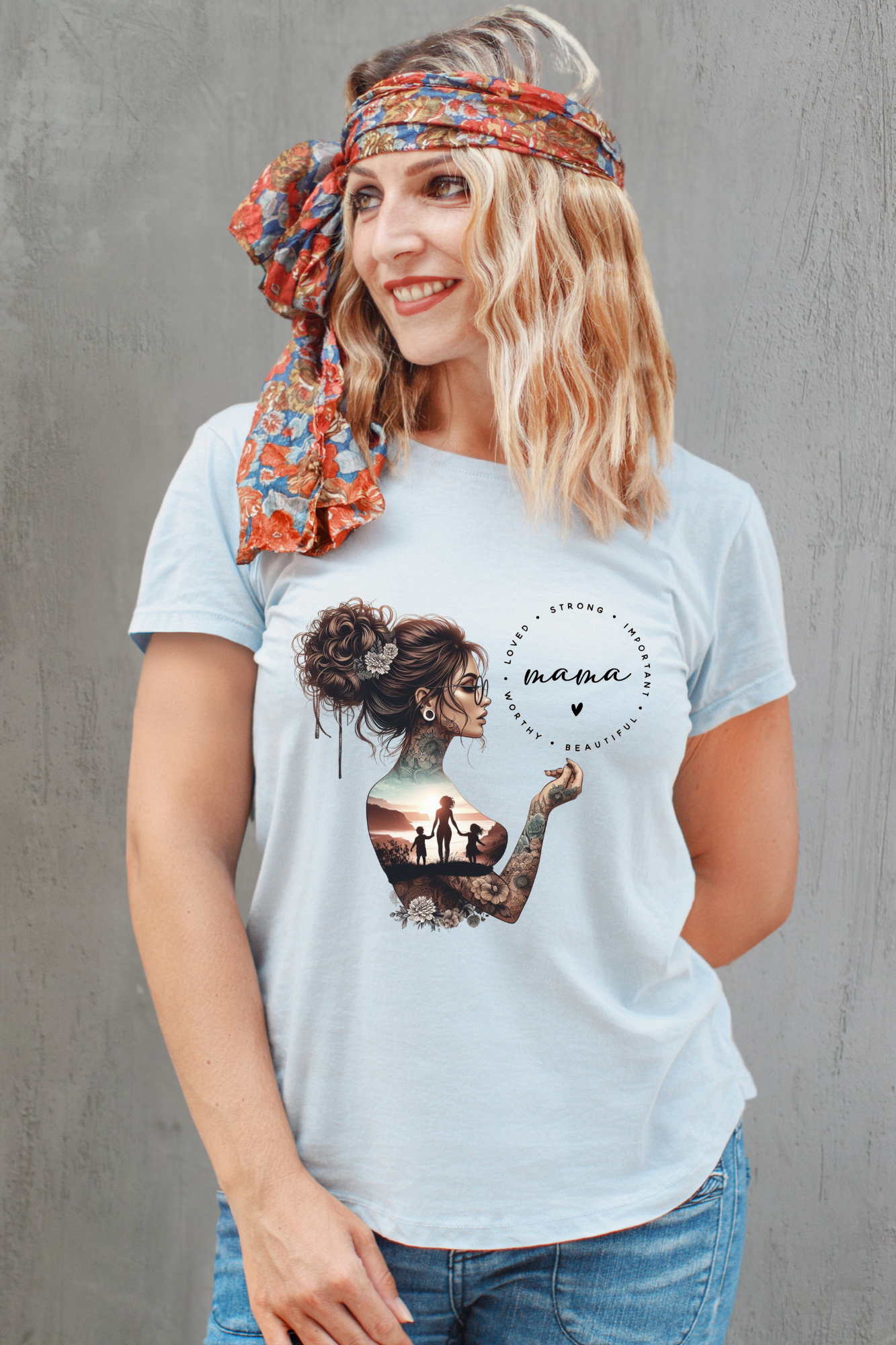 Woman wearing a grey t-shirt with a graphic design on a gray background