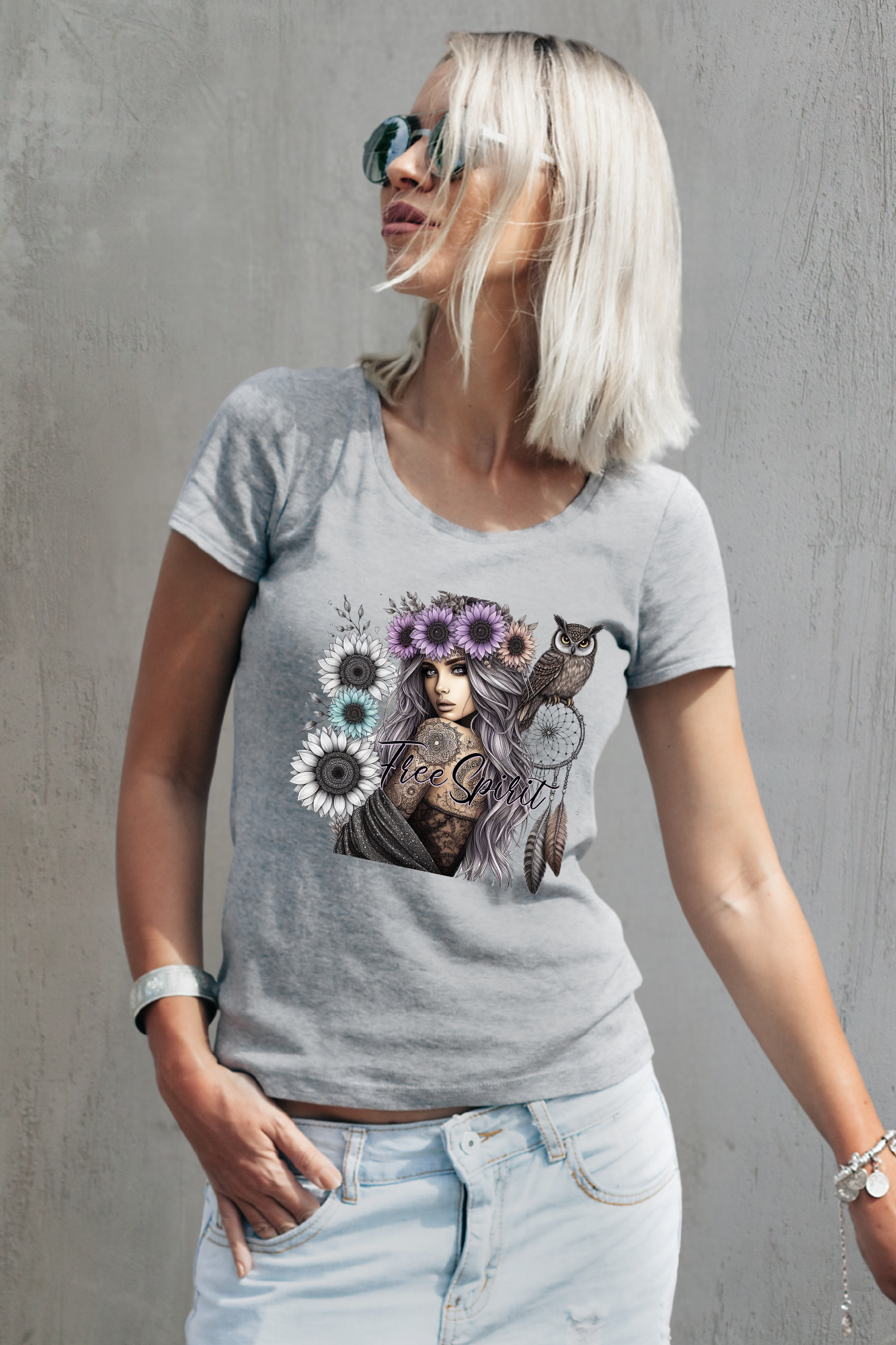 Woman wearing a gray t-shirt with a graphic design against a gray background