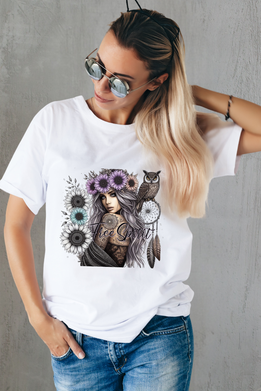 Woman wearing a white t-shirt with a graphic design of a woman with tattoos, flowers, and owls.