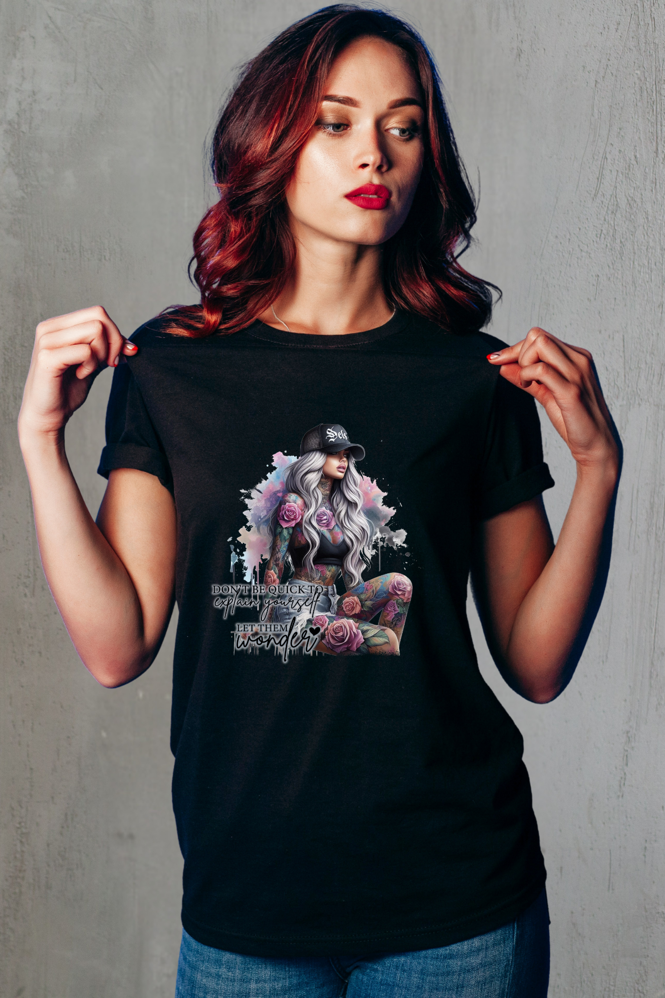 Woman wearing a black t-shirt with a graphic design on a gray background