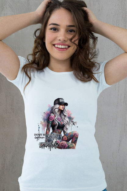 Woman wearing a white t-shirt with a graphic design of a woman with tattoos and flowers.