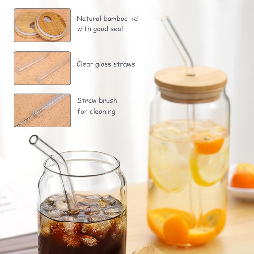 Glass drinkware set with bamboo lid, clear glass straws, and straw brush on a light background.