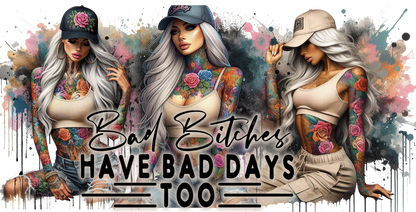 Three women with tattoos and caps, with text 'Bad Bitches Have Bad Days Too' on a colorful abstract background.