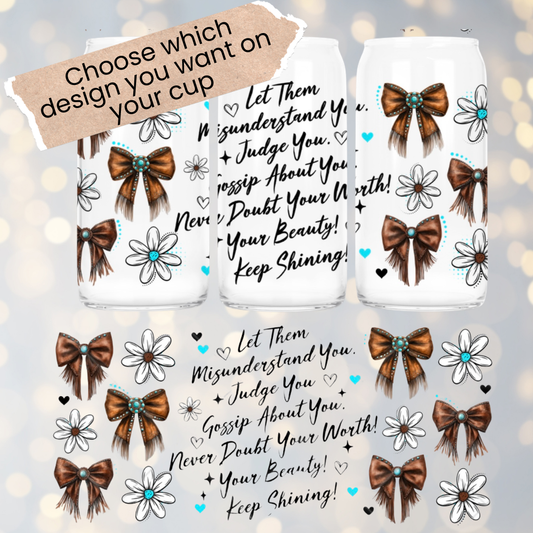 Three clear cups with decorative bows and flowers on a light gray background.