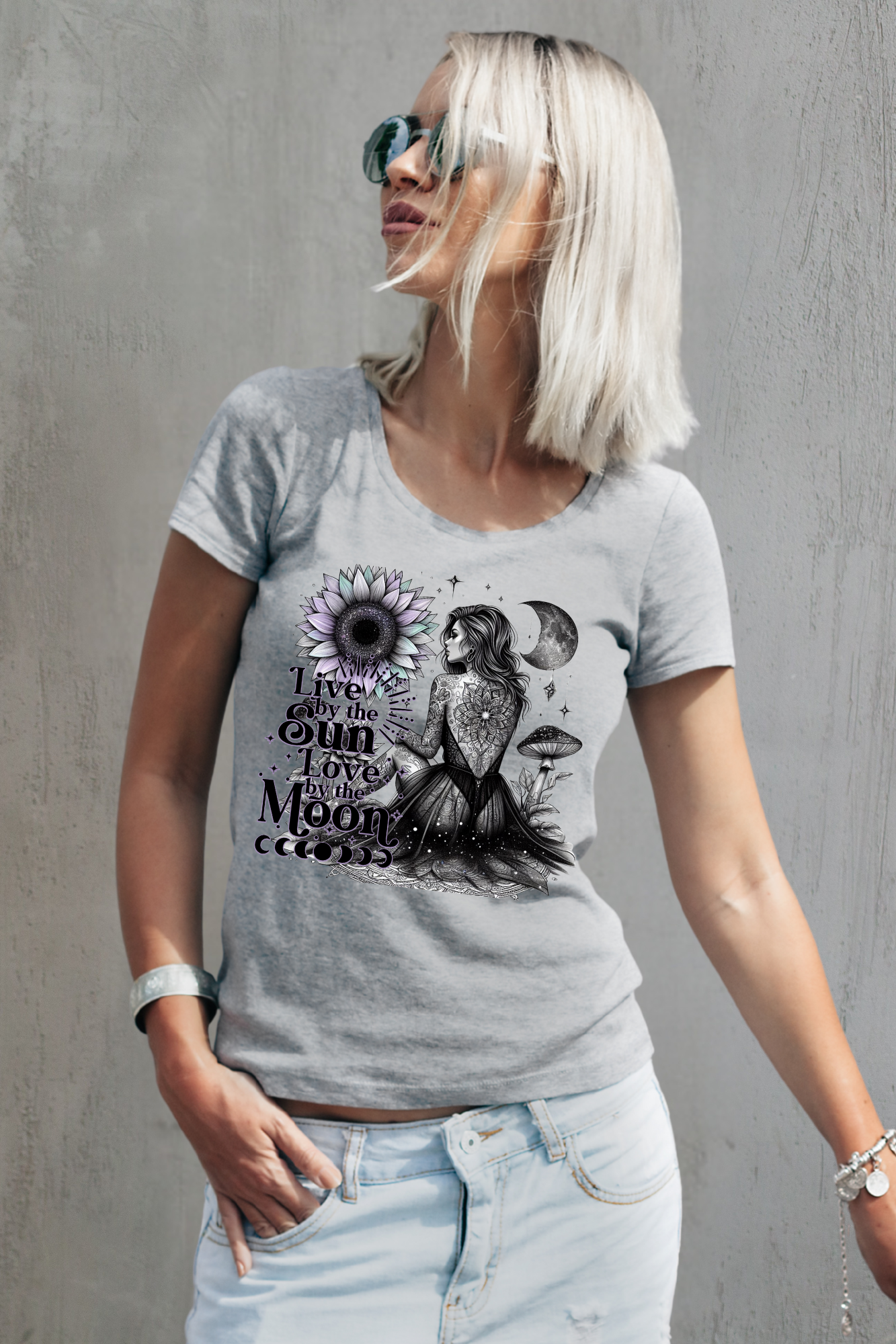 Woman wearing a gray t-shirt with a graphic design against a gray background