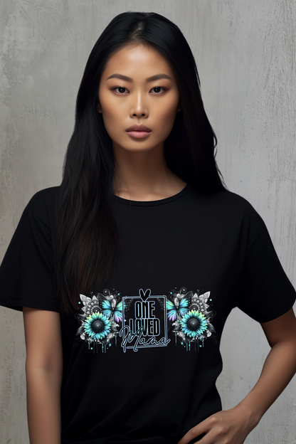 Woman wearing a black t-shirt with a colorful graphic design on a gray background