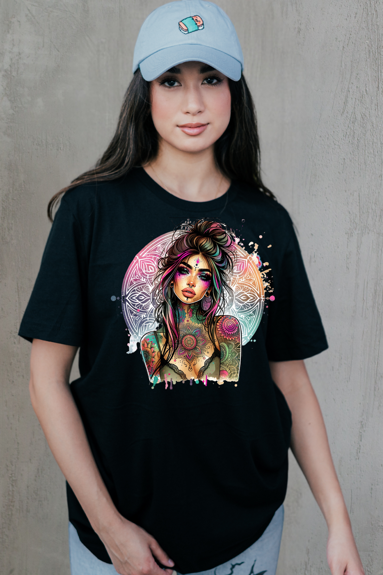 Person wearing a black t-shirt with a colorful graphic design of a woman's face.