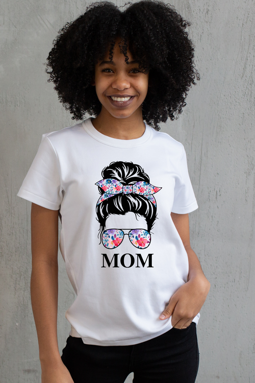 Person wearing a white t-shirt with a graphic design and the word 'MOM'.