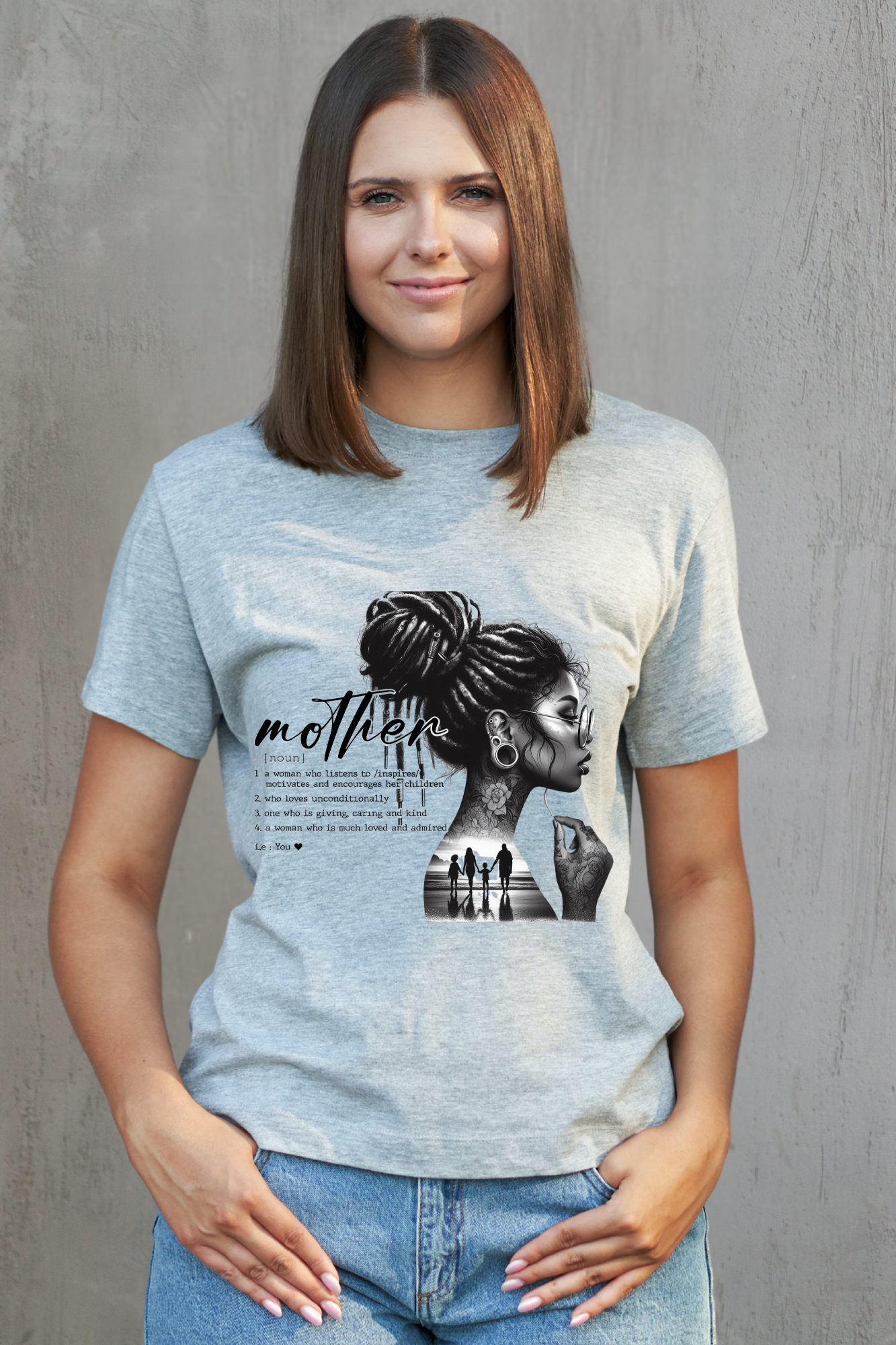 Woman wearing a light blue t-shirt with a graphic design of a woman and text on a gray background