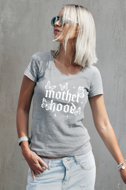 Grey gothic T-Shirt ‘Motherhood’ lettering surrounded by delicate white butterflies and small star accents on a light gray background