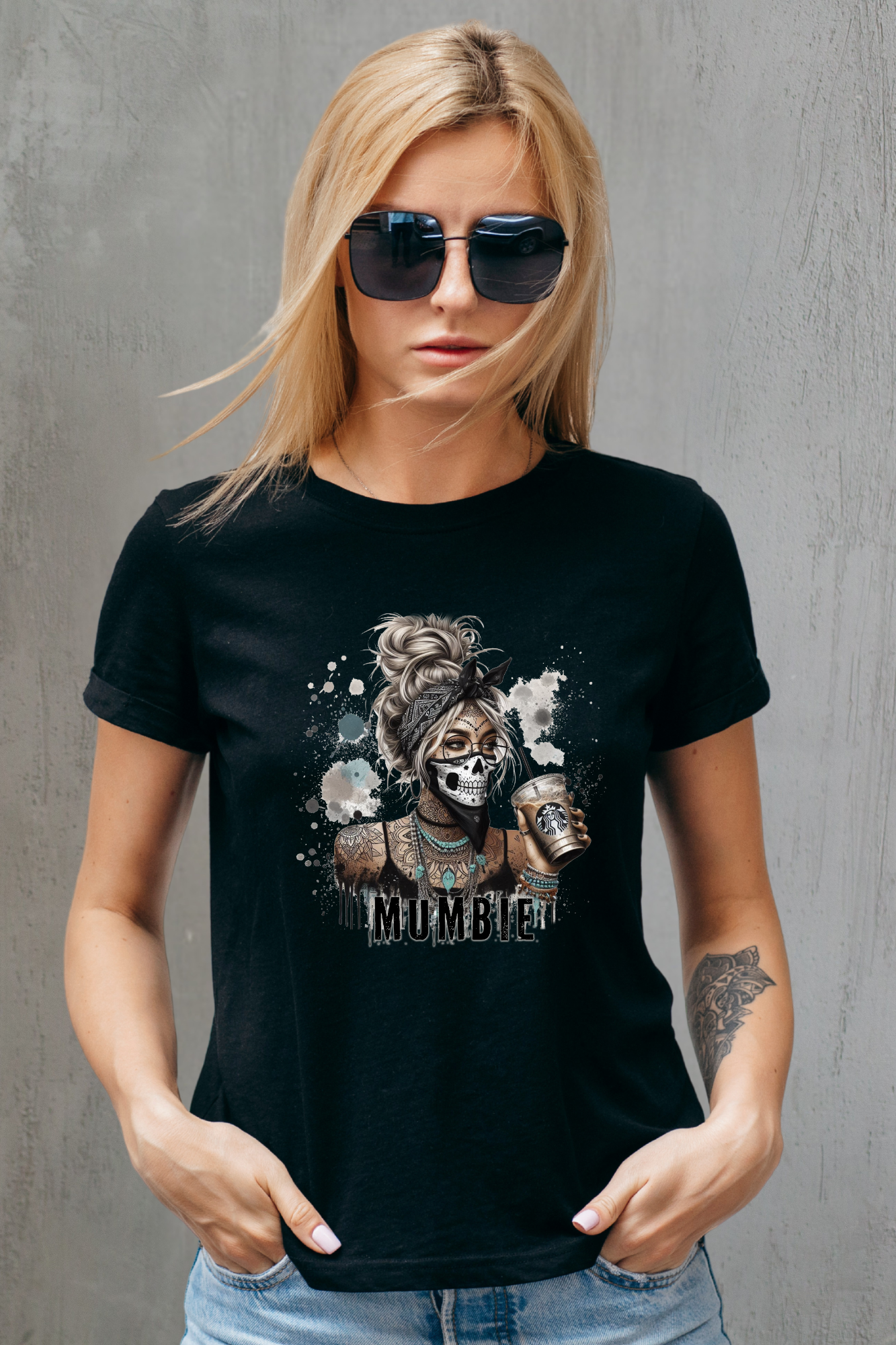 Woman wearing a black t-shirt with a graphic design against a gray background