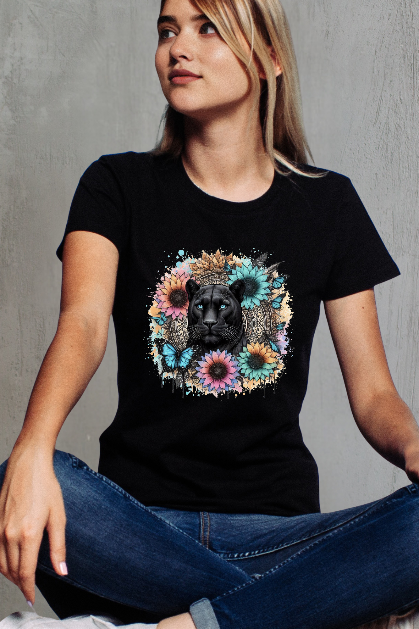 Person wearing a black t-shirt with a colorful floral and panther design against a mandala background