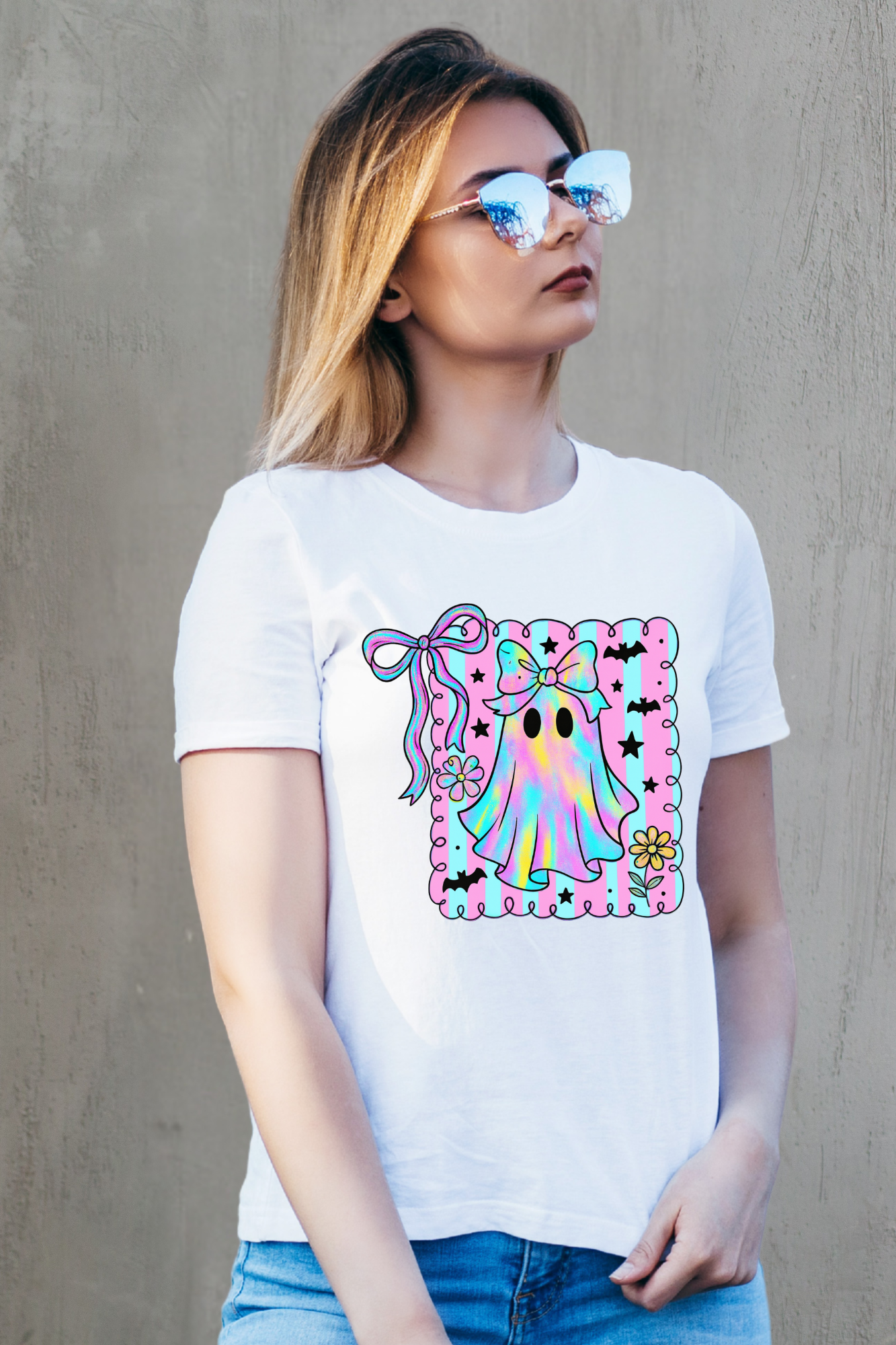 Person wearing a white t-shirt with a colorful graphic design against a gray background