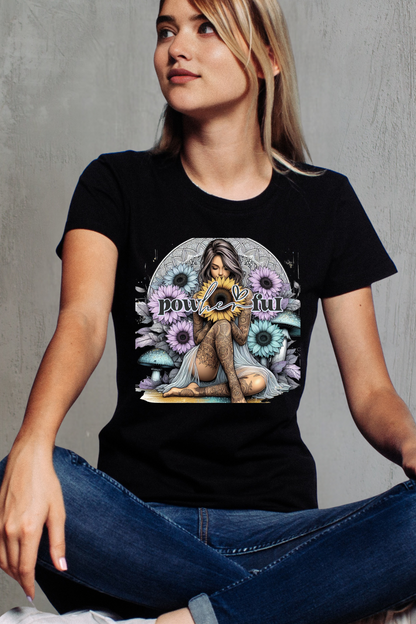 Person wearing a black t-shirt with a colorful graphic design of a woman and flowers.