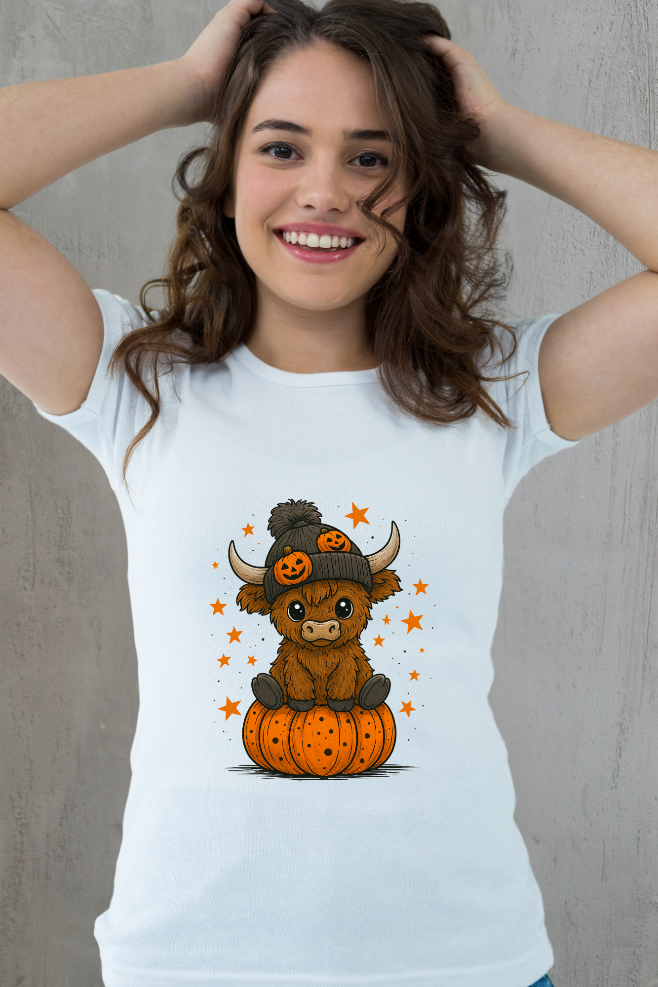Woman wearing a white t-shirt with a cartoon cow on a pumpkin design.