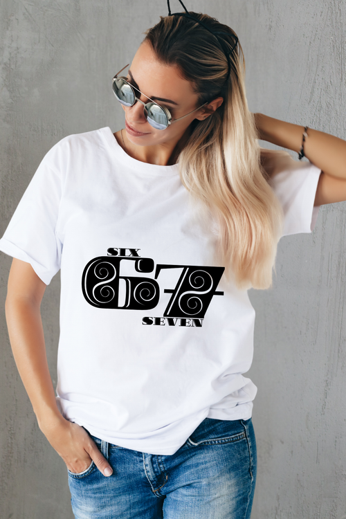 Woman wearing a white 67 t-shirt with a black graphic design on a gray background