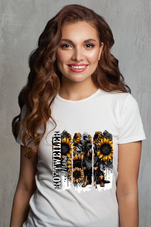 Woman wearing a white t-shirt with sunflower design and Rottweiler against a white background