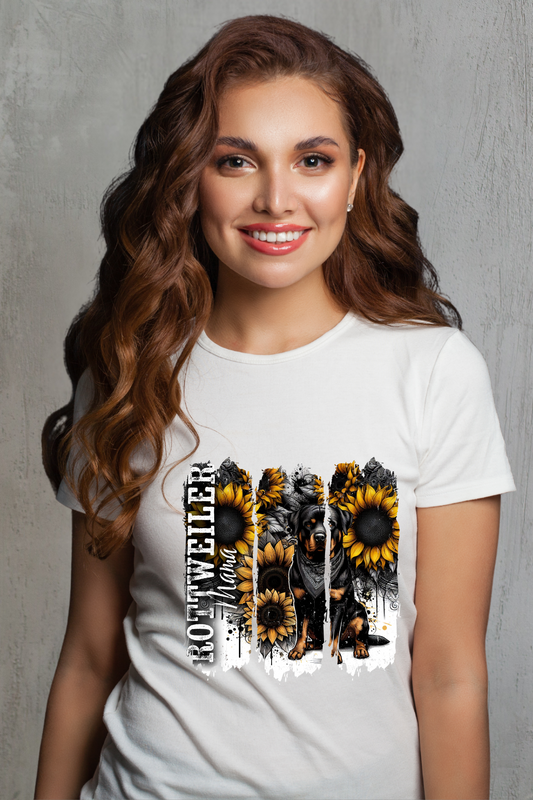 Woman wearing a white t-shirt with sunflower design and Rottweiler against a white background