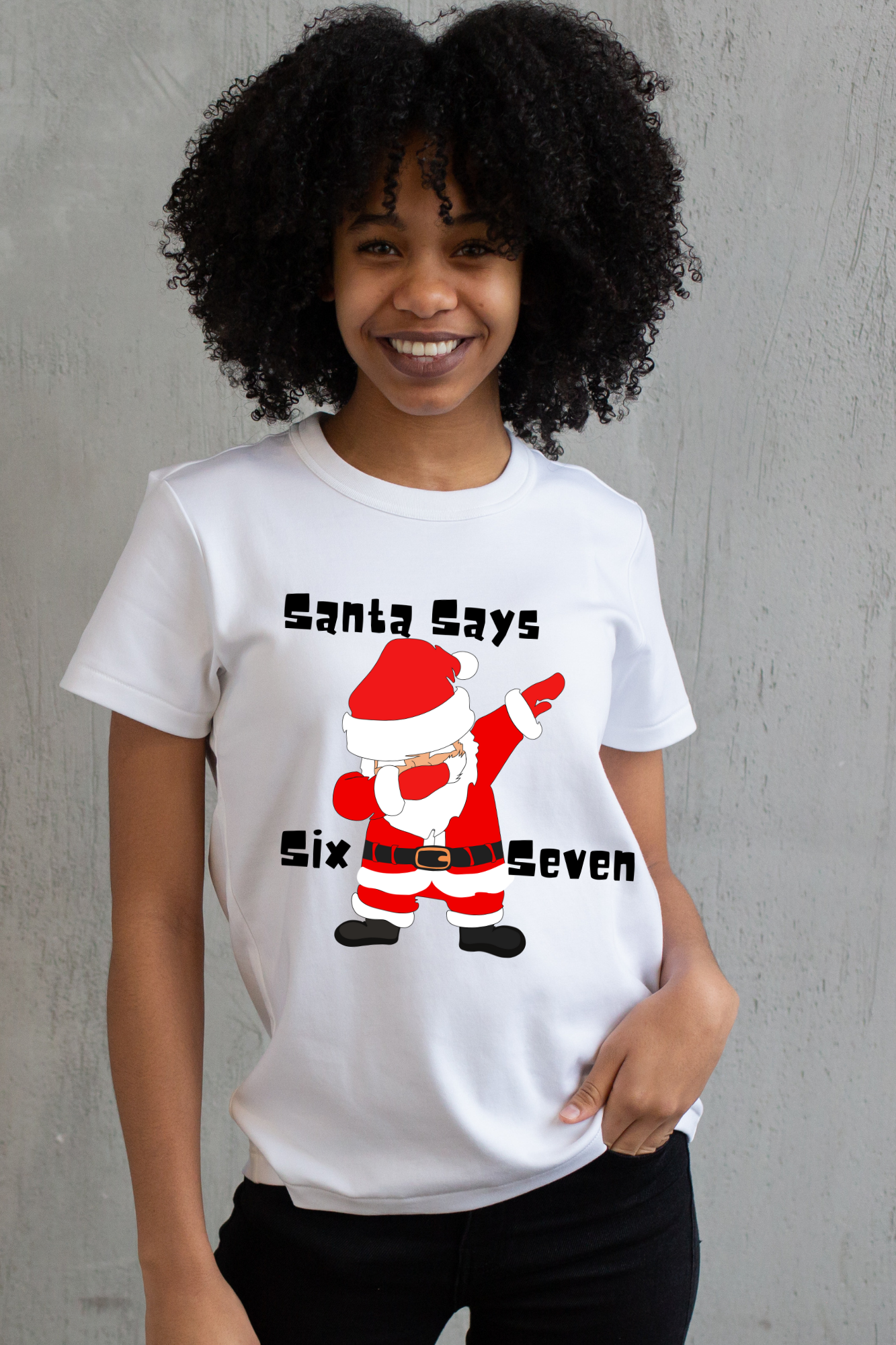 Person wearing a white t-shirt with a graphic of Santa Claus and 67 text, standing against a white background