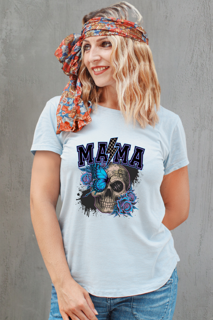 Woman wearing a light blue t-shirt with a skull design and 'MAMA' text, standing against a gray background.