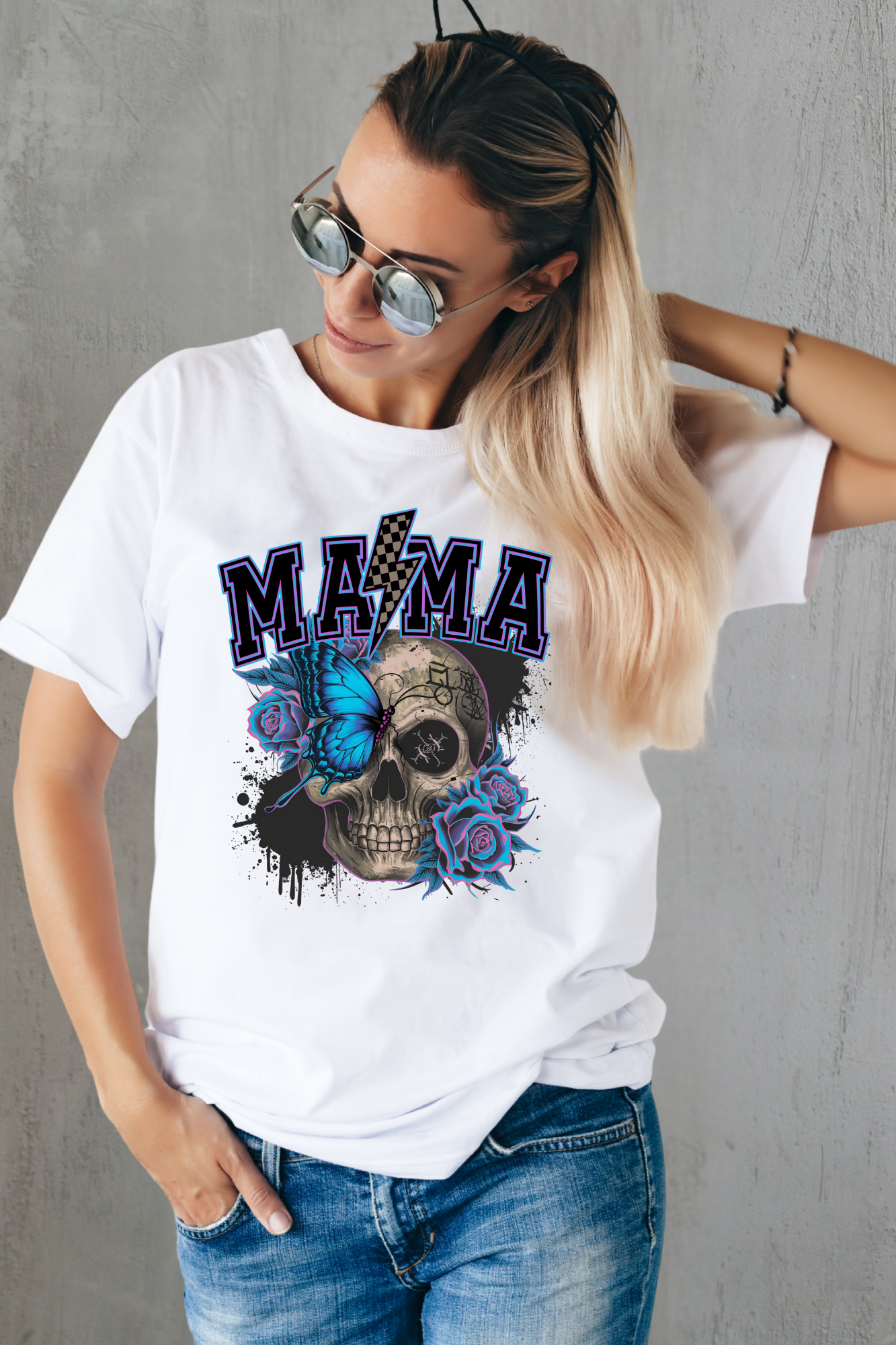 Woman wearing a white t-shirt with a graphic design and text, standing against a gray wall.